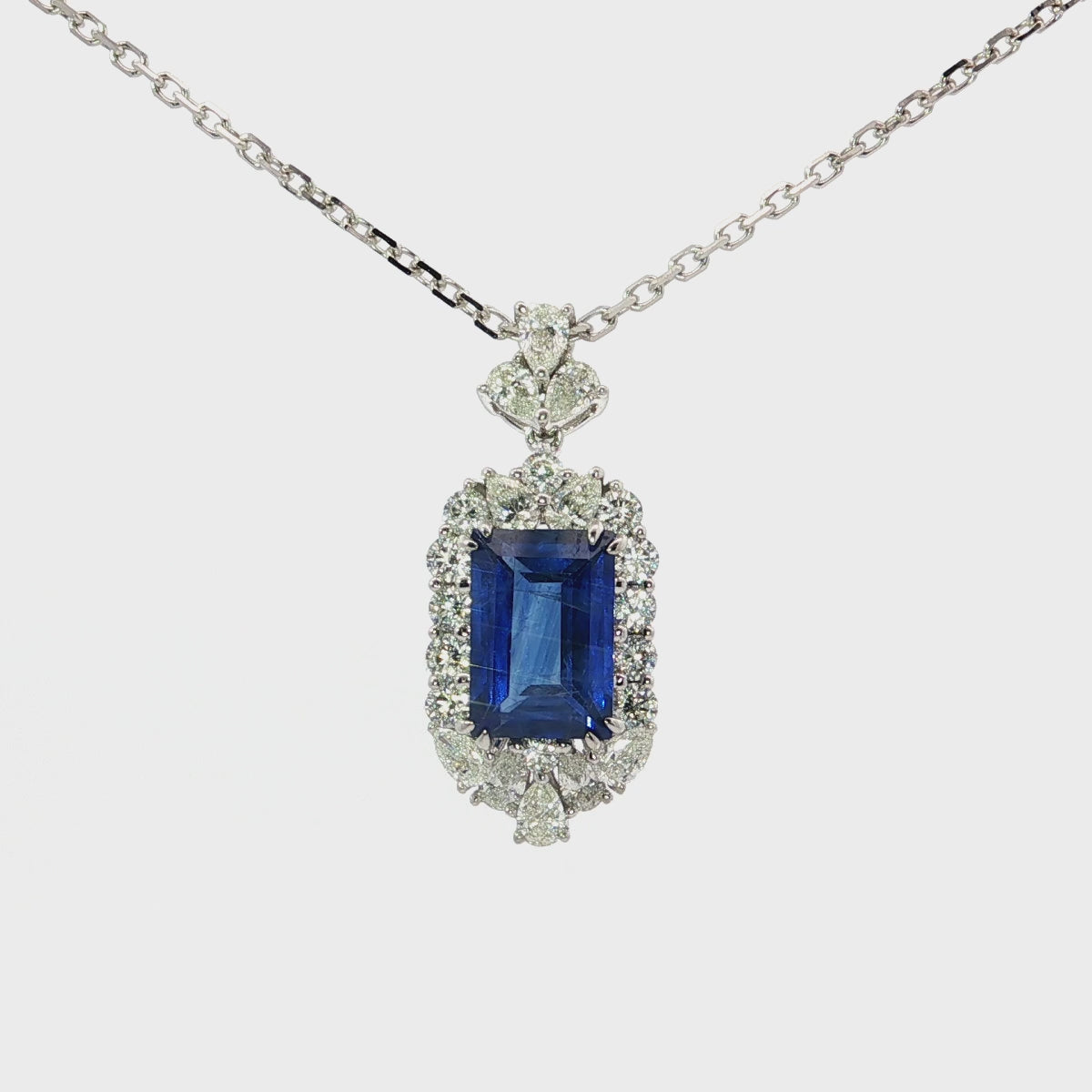 Load video: White Gold Charm Necklace with Deep Blue Emerald Cut Sapphire